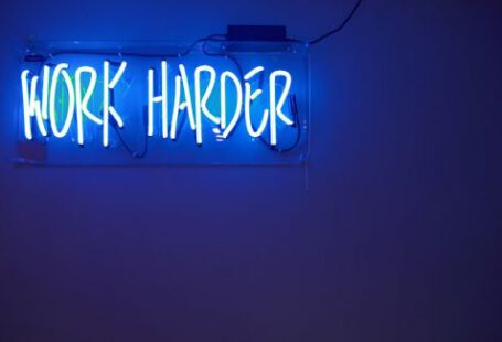 Trading - blue Work Harder neon signage